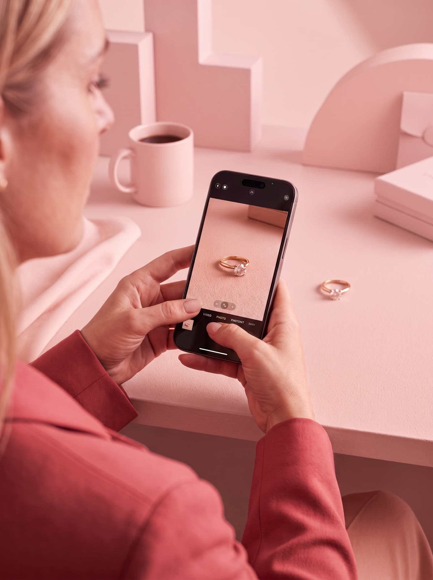 Photographing a gold ring on a phone at a kitchen table